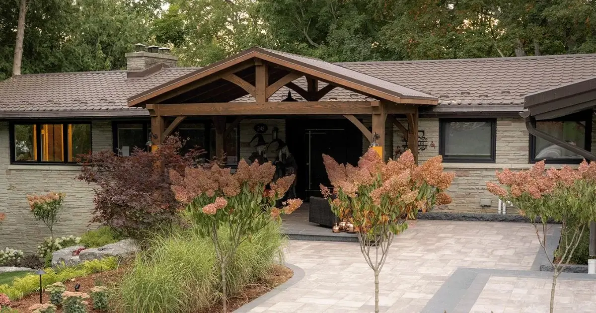 Timber frame front entry addition with covered porch and exposed wood beams