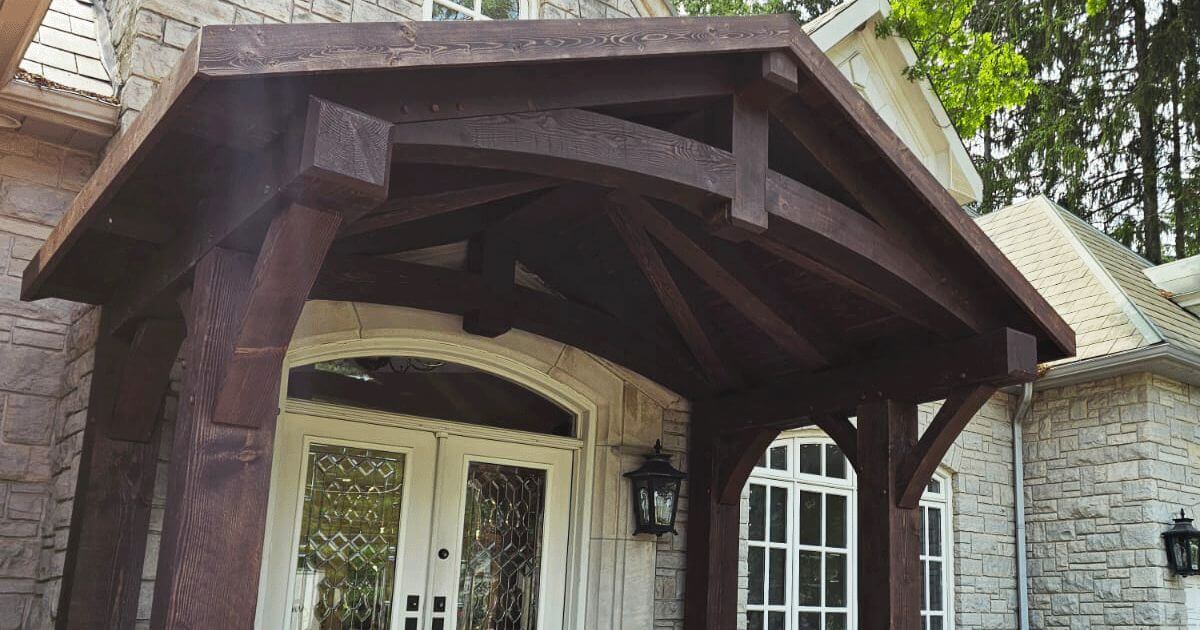Custom timber frame entrance with exposed wood beams