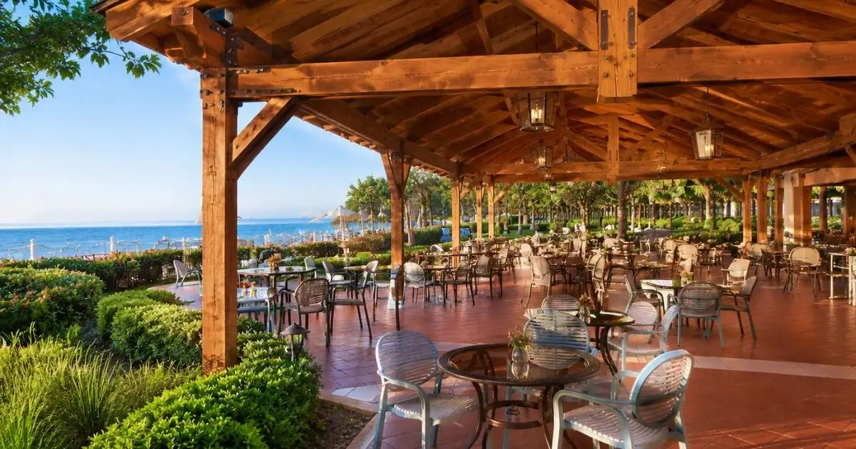 Outdoor restaurant beneath a large timber-framed pavilion.
